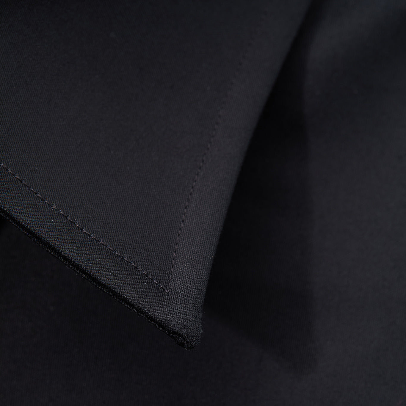 Close-up of black shirt collar tip